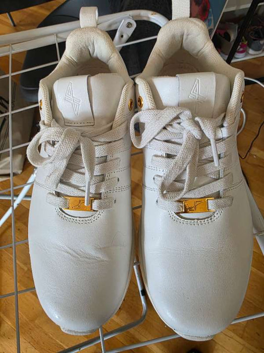 White leather sneakers with gold details